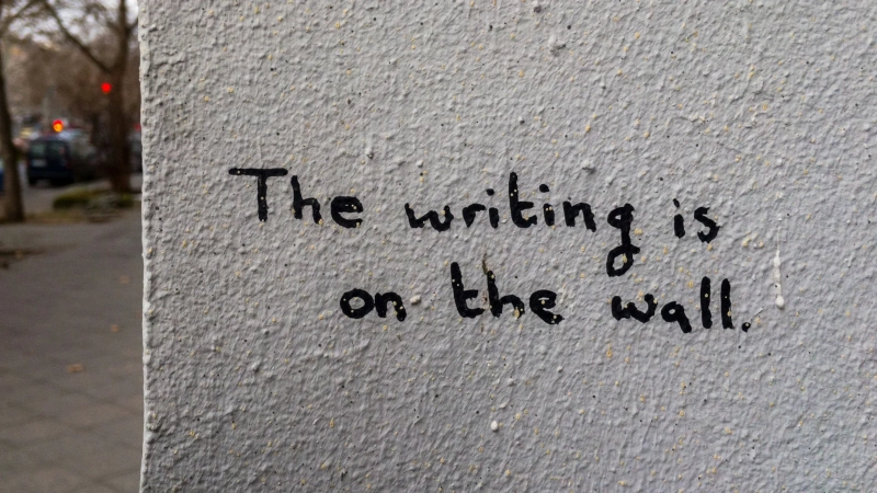 The writing in the wall graffiti. Photo by Randy Tarampi on Unsplash
